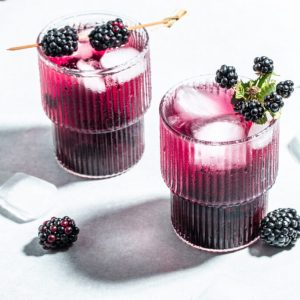 Refreshing lemonade with blackberry on a white background. place for text, top view.